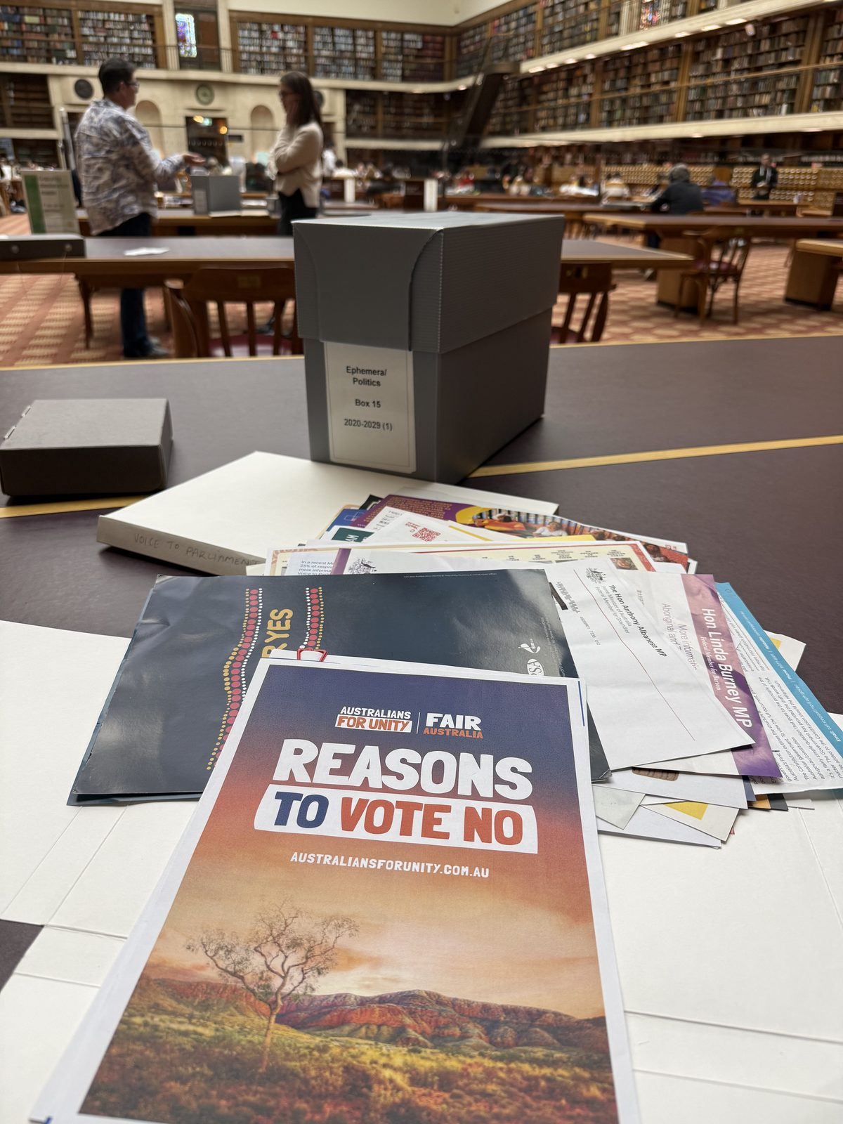 Referendum campaign ephemera spread on a desk in the Mitchell Library reading room